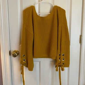 Yellow off-shoulder sweater with bow sleeves